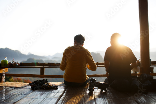 Two best friend eating noodle with landscape of mountain in the morning