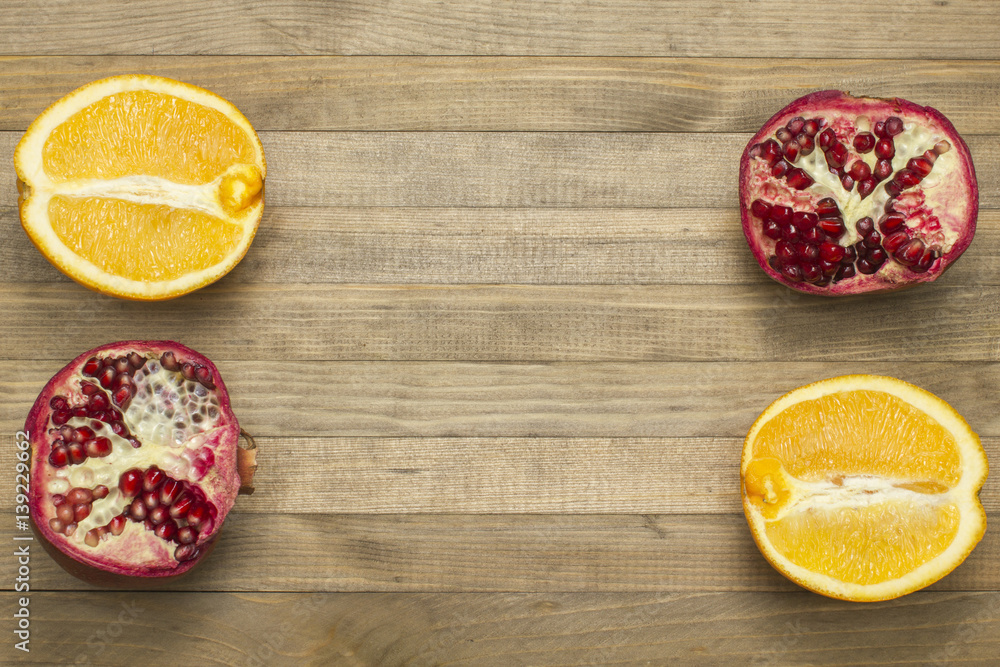 group pomegranate and orange fruit lay on wooden table