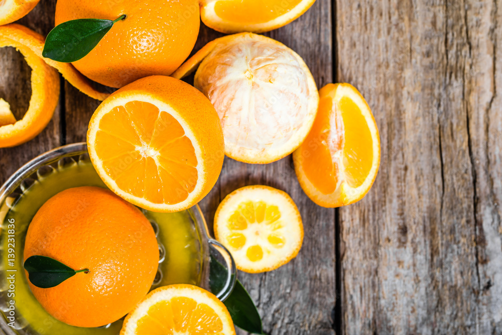 Squeezed orange juice and fresh oranges fruits, flat lay, overhe Squeezed orange juice and fresh oranges fruits, flat lay, overhe