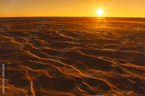 Martian sunset  Mars planet  red landscape. Looks like cold desert on Mars. A huge field of ice