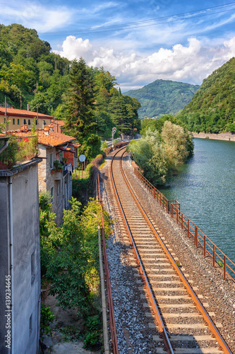 Railroad along river in Italy