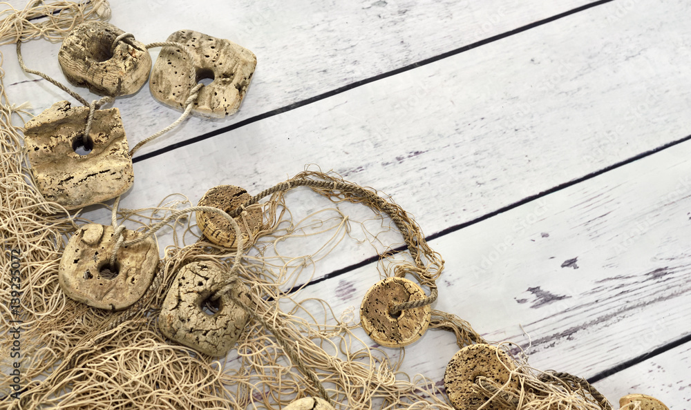 Fishing net or nautical vessel on wooden planks. Beach background or summer background with copy space. Fishing net or nautical vessel on wooden planks. Beach background or summer background with copy space.