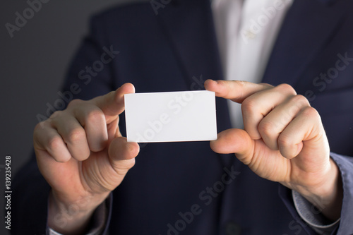 businessman holding blank visit card