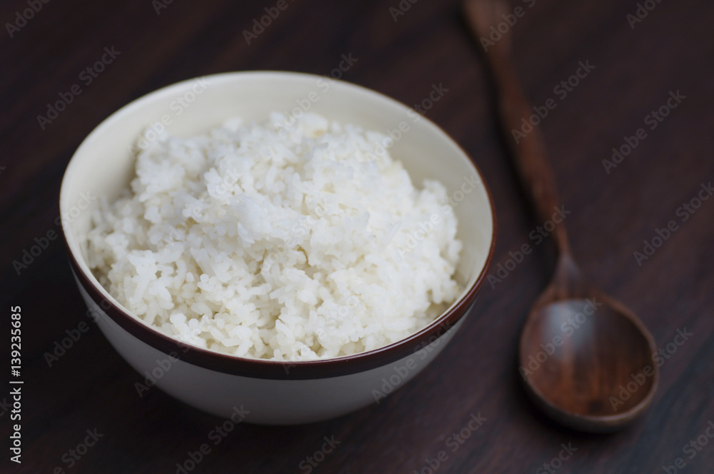Thai riec in bowl with wooden spoon on table Thai riec in bowl with wooden spoon on table