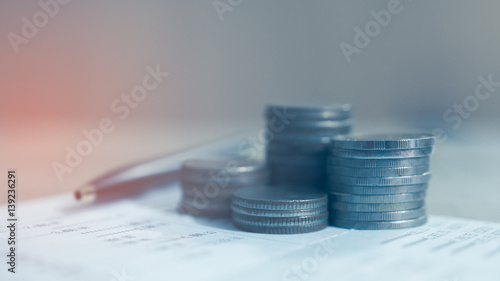 Double exposure of rows of coins on account book, Concept finance banking and save