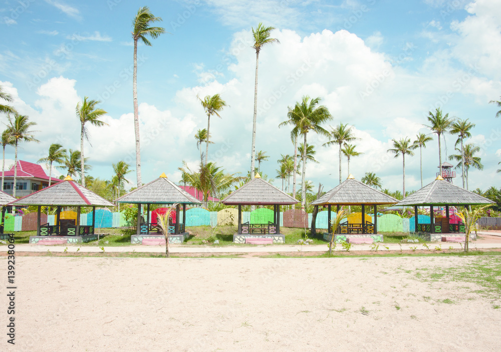 Several huts on the beach used for relaxation and shelter from the sun with palm trees at the  background and nobody around, Singkawang Borneo.