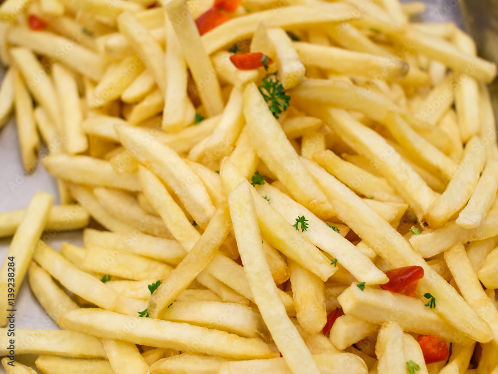 French fried background. Closeup shot. Potato snack. French fried background. Closeup shot. Potato snack.