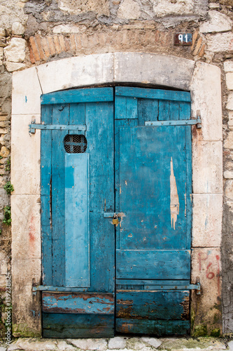 old wooden doorway and stone facade © TTLmedia