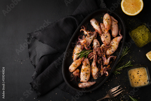 Grilled squid in breadcrumbs with lemon and spices photo