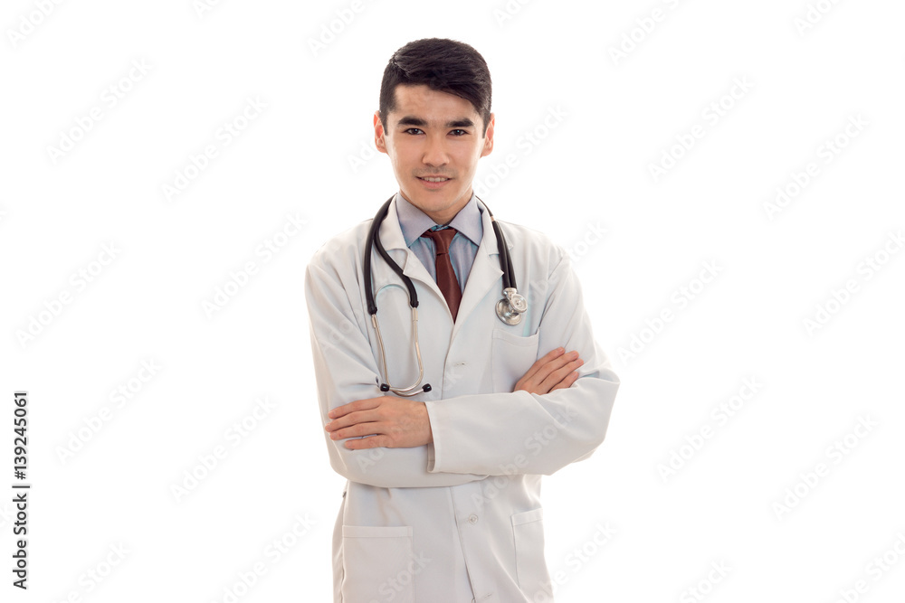 a young doctor with stethoscope and white coat looking at camera a young doctor with stethoscope and white coat looking at camera