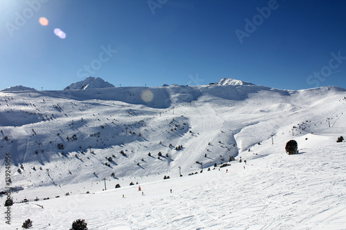 Fresh ski slopes and mountains in sunny day in Andorra photo