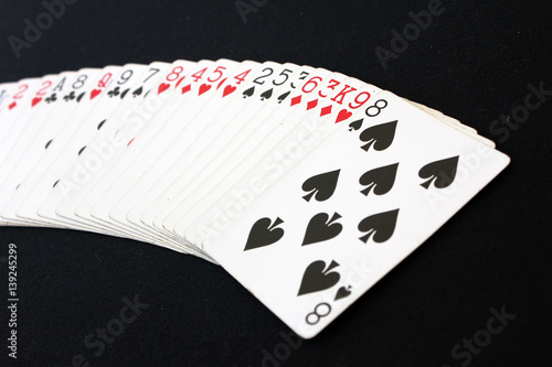 The combination of playing cards poker casino. Isolated on black poker table background.