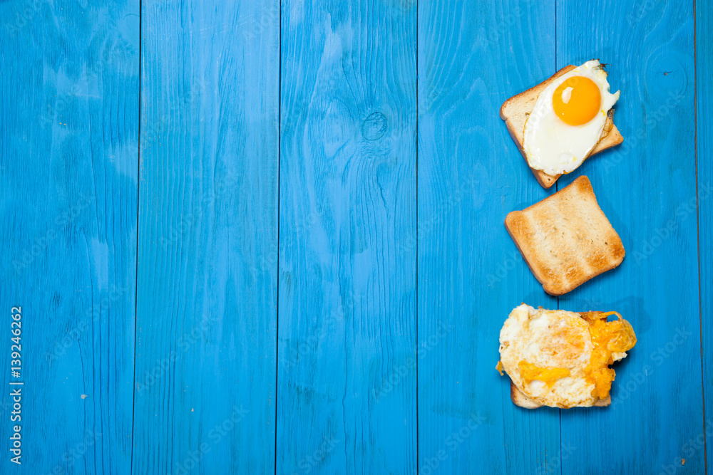 Toasts and egg on a blue wooden table Toasts and egg on a blue wooden table