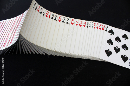 The combination of playing cards poker casino. Isolated on black poker table background