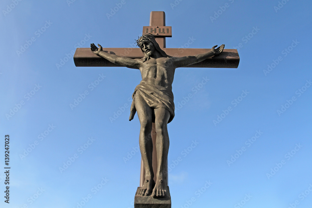 A large crucifix with Jesus Christ in a crown of thorns kolyuchemm open-air view of a close-up right.