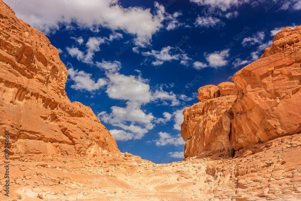 Clouds over a barren, empty desert canyon