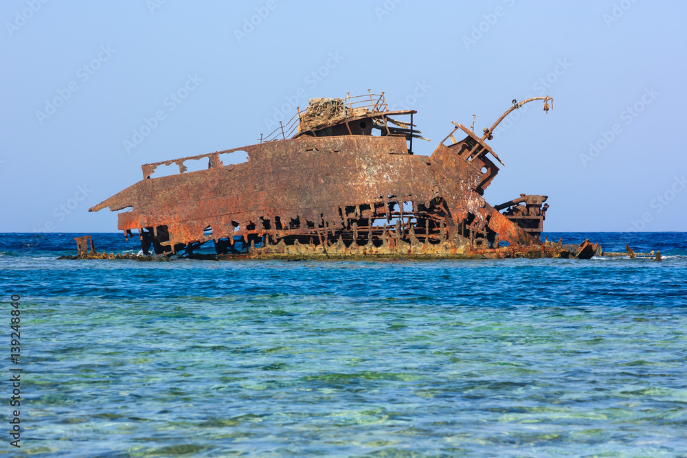 Rusting metal shipwreck on a coral reef