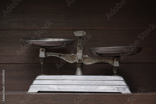 Scales / View of old scales on dirty wooden shelf. Dark tone. Shallow depth of field.