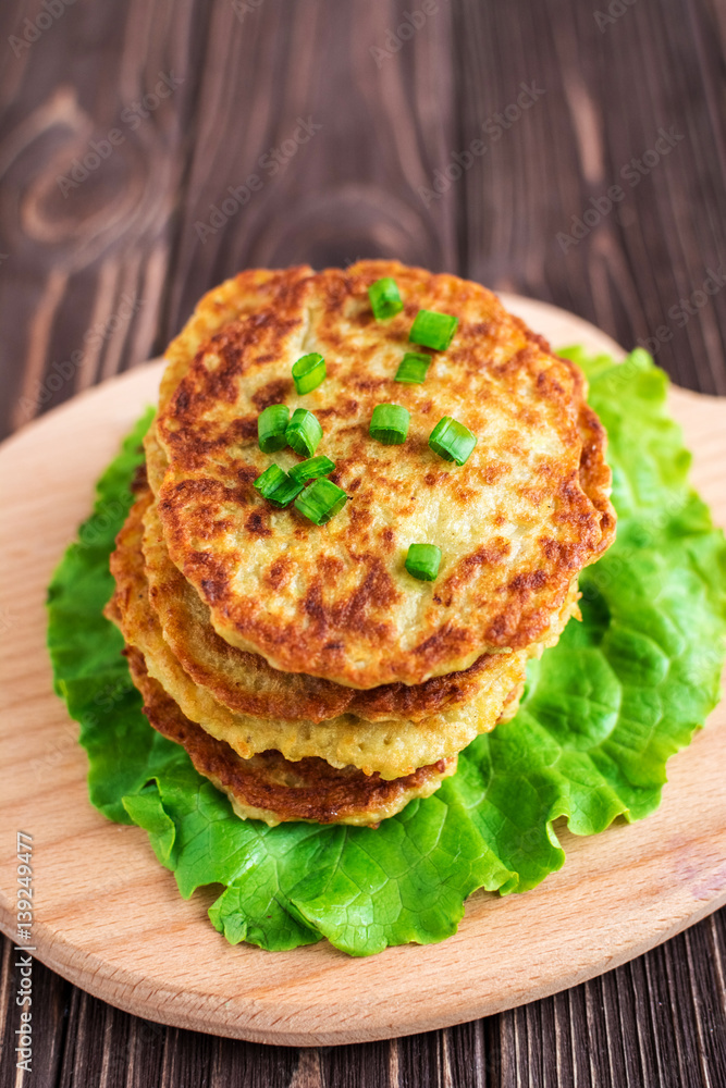 Fried potato pancakes on wooden background Fried potato pancakes on wooden background