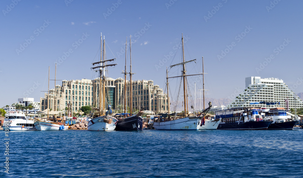 Moored pleasure boats, sailboats and yachts in marina of Eilat - famous resort and recreation city in Israel