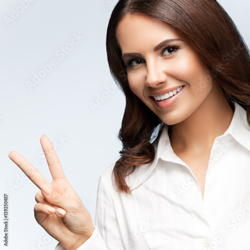 businesswoman, showing two fingers or victory gesture