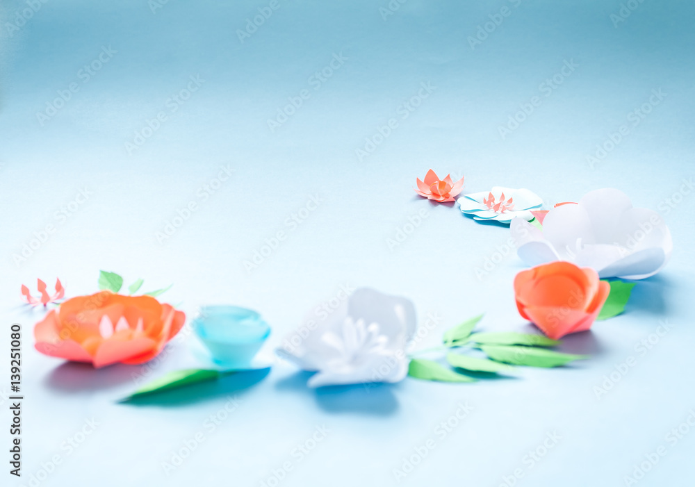 semicircle frame with color paper flowers on the blue background. Nature concept
