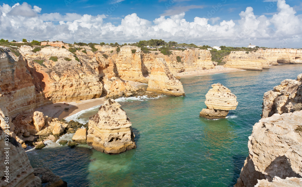 Algarve coast with bays and caves, South Portugal. Turquoise ocean water.