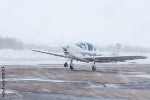 Small plane at the airport in winter