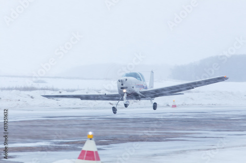 Small plane at the airport in winter