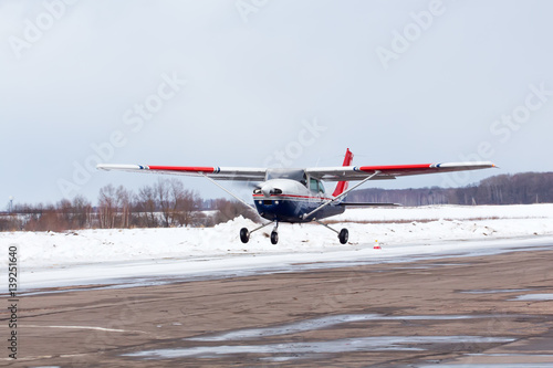 Small plane at the airport in winter