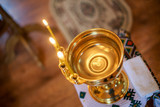 The font for the baptism of an infant with burning candles. Interior Of Orthodox Church In Easter. baby christening. Ceremony a in Christian . bathing the into the baptismal font. Soft focus