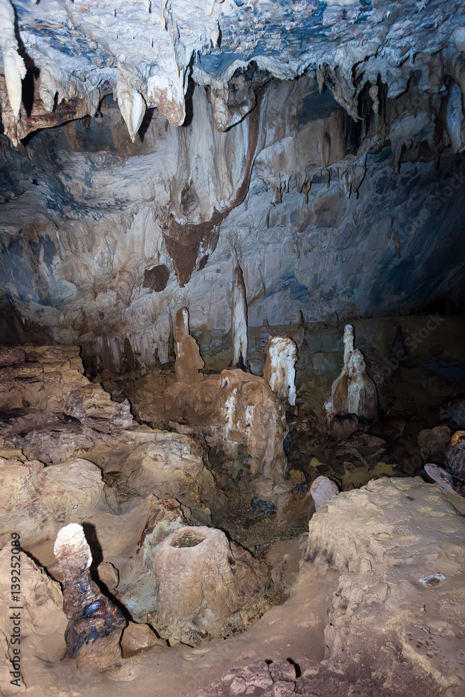 Rock formations and water in a deep underground cave