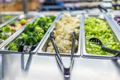 Foto Broccoli, cauliflower and celery in salad bar counter