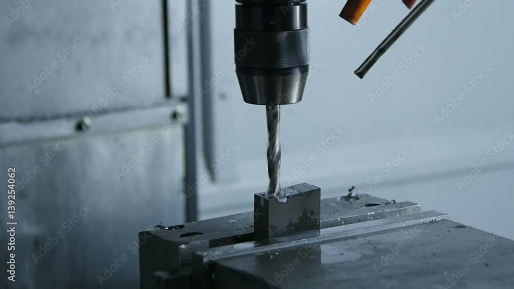 New Drill Machine Makes Hole in Workpiece against Grey Background New Drill Machine Makes Hole in Workpiece against Grey Background
