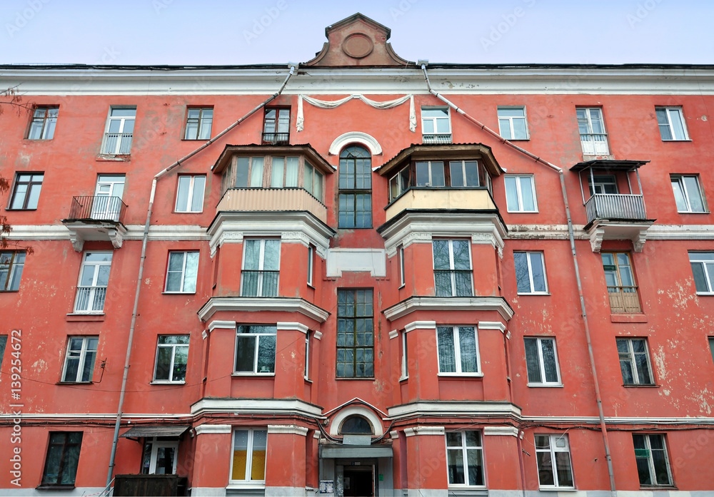 Obraz premium Ancient red brick building with bay windows, balconies and gutters on the street of Minsk, Belarus