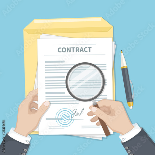 Contract inspection concept. Businessman hands holding magnifying glass over a contract. Contract with signature and stamp. Research documents.