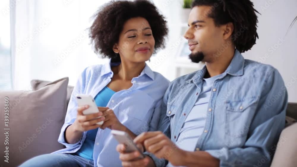happy couple with smartphones at home happy couple with smartphones at home