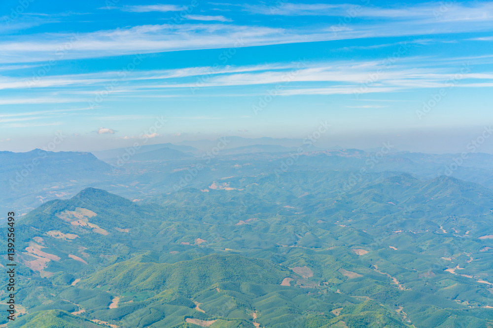 Fototapeta premium Mountains under clouds. View from the airplane .