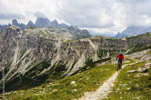 View of cyclist riding mountain bike on trail in Dolomites,Tre Cime di Laverado, South Tirol, Italy © Gorilla