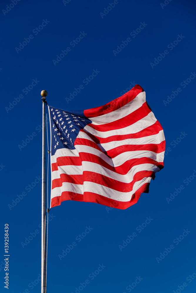 Fototapeta premium American Flag against blue sky
