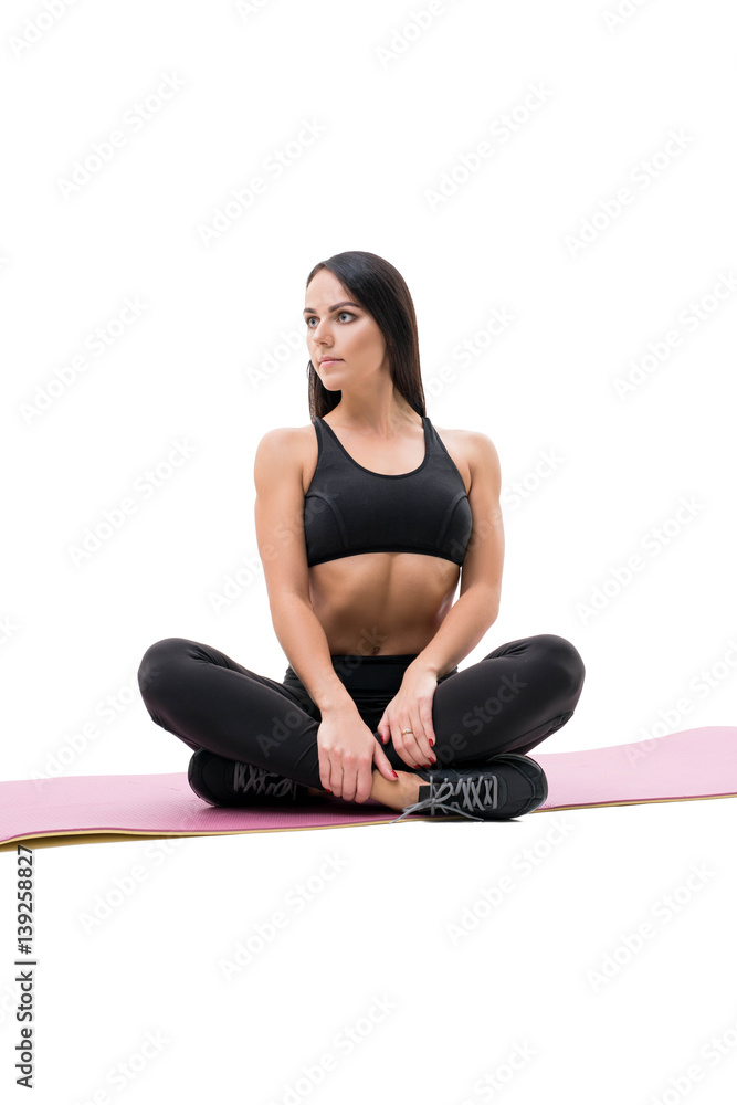 Vertical shot of fitness woman relaxing on mat Vertical shot of fitness woman relaxing on mat
