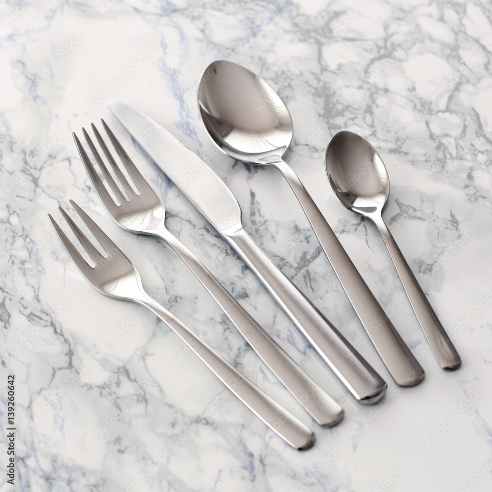 Modern cutlery on a marble table Modern cutlery on a marble table