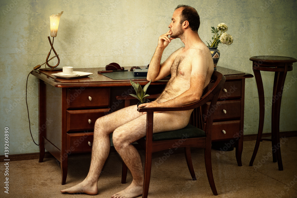 Fototapeta premium handsome naked man sitting thoughtful in the chair