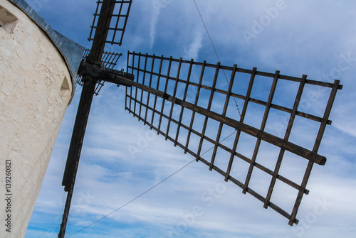 A close-up view to an old windmill on the hill near Consuegra (Castilla La Mancha, Spain), a symbol of region and journeys of Don Quixote (Alonso Quijano). photo