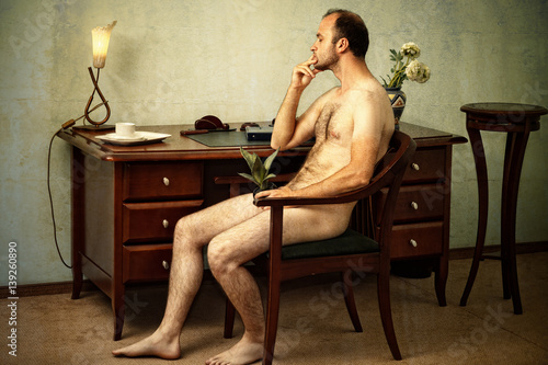 Naked man sitting down