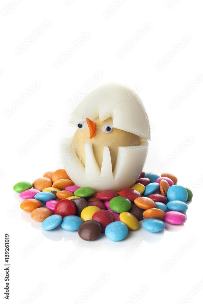 Food art creative concepts. Cute chicken on candy nest over white background. Food art creative concepts. Cute chicken on candy nest over white background.