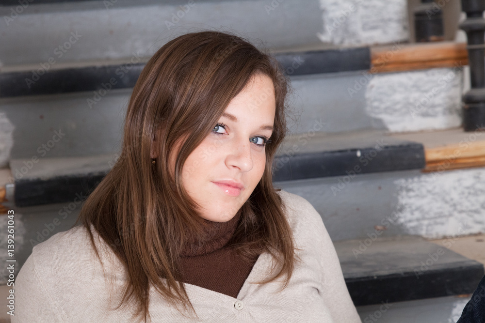 Fototapeta premium Sexy girl looking at camera sitting on steps