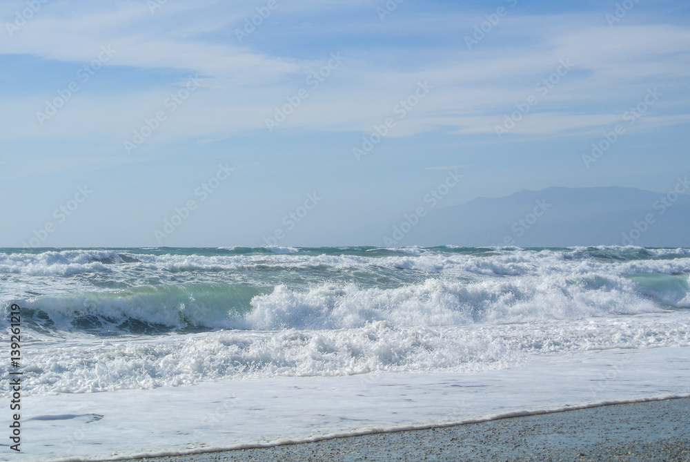 Sea waves with foam at the shore of national park Cabo de Gata near Almeria, Andalusia, Spain.