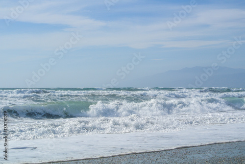 Sea waves with foam at the shore of national park Cabo de Gata near Almeria, Andalusia, Spain.