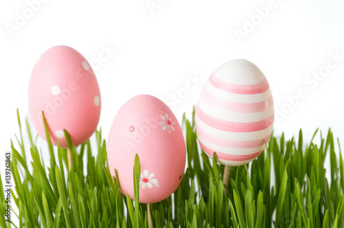 Pink Easter eggs and green wheat plant